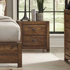 a bedroom scene with focus on the bed and nightstands that have drawers in them