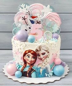 a frozen princess birthday cake with the number five on it