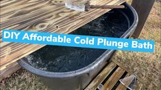 a large metal tub filled with water next to a wooden table