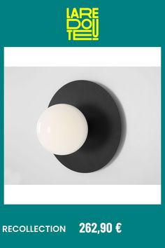 a black and white plate with an egg on it, in front of a green background