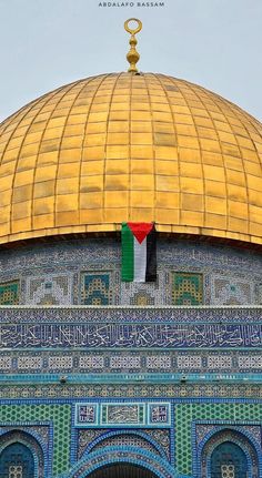 an ornate dome with a flag hanging from it's side