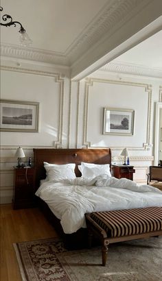 a bedroom with a large bed and white walls