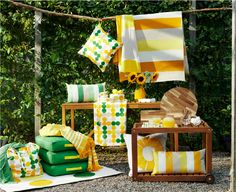 yellow and green decor is on display in front of some trees with sunflowers