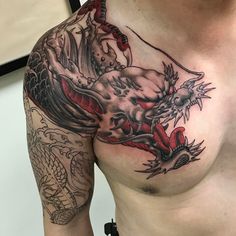 a man with a dragon tattoo on his chest