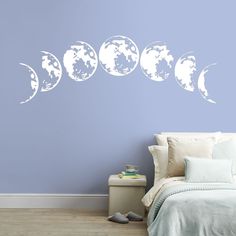 the moon phases wall decals are shown in this bedroom