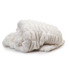 a pile of white towels folded on top of each other in front of a white background