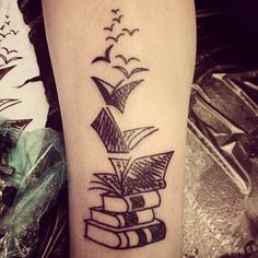 a black and white photo of a tattoo with books