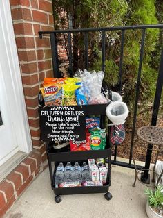 a black cart filled with lots of food sitting on top of a porch