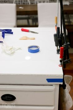 a white table topped with scissors and other items