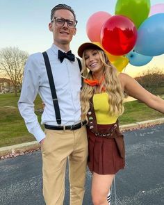 a man and woman standing next to each other with balloons in the air behind them