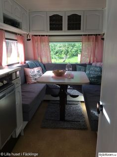 a kitchen with a table and couch in it