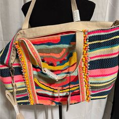 America And Beyond Nwt Tote. This Stunning Tote Is Hand Embellished With Thousands Of Beads And Rows Of Embroidery In Shades Of Roses Pink, Baby Blues, Silver, And Sunny Yellows. Micro Pom Pom Line The Amazing Bead Work Which Then Gives Way To Handwoven Jacquard. Light Weight But Roomy, This Bag Can Take You From Lunch With The Girls And Is Perfect For An Holiday Trip. Whether You're Headed Out The Door Or Jumping On A Plane, This Will Be The Bag You Grab For Years To Come. Handwoven Jacquard Be Vibrant Multicolor Bags For Summer, Vibrant Multicolor Summer Bags, Travel Multicolor Beaded Shoulder Bag, Multicolor Embroidery Shoulder Bag For Beach, Multicolor Beaded Bags For Summer, Beaded Multicolor Bags For Shopping, Spring Travel Beaded Bags, Summer Multicolor Beaded Bag, Multicolor Embroidered Vacation Bag