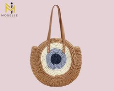 Introducing our unique handmade light brown straw tote bag featuring a stunning evil eye design - the perfect statement accessory for any outfit! Crafted with care and attention to detail, this beautiful bag is made from high-quality, eco-friendly straw that's both durable and sustainable. The eye-catching evil eye design in shades of light brown adds a touch of exotic charm to the design, making it a must-have for any fashion-forward individual. With plenty of space for all your essentials, thi Trendy Handmade Brown Beach Bag, Trendy Handmade Beige Beach Bag, Trendy Handmade Straw Beach Bag, Handmade Brown Beach Bag For Summer, Handmade Brown Straw Bag For Beach Season, Trendy Handmade Jute Straw Bag, Trendy Handmade Straw Bag For Beach, Trendy Handmade Straw Bag For The Beach, Summer Beach Bag