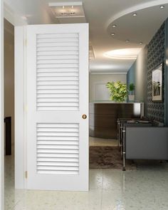 an open door leading to a living room with a plant on the table in front of it