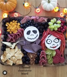 a halloween platter with fruit, crackers, and other food items on it