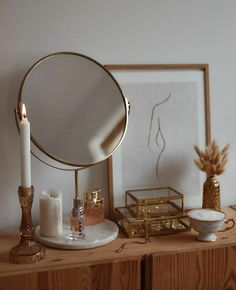 a mirror, candle and other items on a table