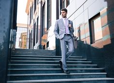 a man in a suit walking down some steps