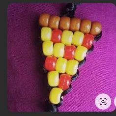 a piece of food that is shaped like a corn on the cob with candy in it