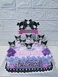 a birthday cake decorated with cats and flowers