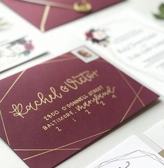 the wedding stationery is laid out on top of each other, including envelopes