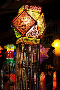 a colorful lamp is lit up in the dark with many lights on it's sides