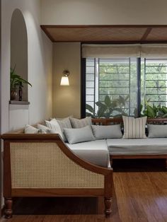 a living room filled with lots of furniture next to a wooden floor and window sill