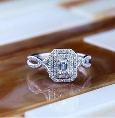 a diamond ring on top of a wooden table