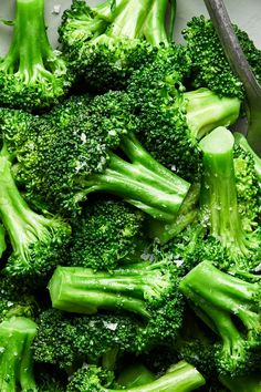 broccoli florets in a bowl with a spoon