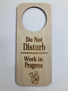 a wooden door hanger with the words do not disturb work in progress on it