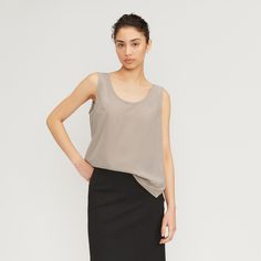 As smooth as silk. The ultimate throw-on-and-go top, The Clean Silk Scoop-Neck Tank is effortless style encapsulated. It features a simple double scoop neckline—front and back, and a relaxed, fluid fit. Made with 100% silk, it adds the perfect pop of luxury to any look. Milled at a GOTS-certified facility, dyed at a bluesign®-certified dyehouse, and made at a LEED-certified factory, our Clean Silk is free of harmful chemicals and uses less energy throughout the production process, compared Chic Solid Color Tops With Scoop Back, Chic Solid Tops With Scoop Back, Elegant Spring Top With Scoop Back, Elegant Scoop Back Top For Spring, Elegant Scoop Neck Top For Layering, Classic Scoop Neck Top For Workwear, Classic Scoop Neck Top For Work, Everlane Summer Workwear Tops, Elegant Summer Blouse With Scoop Neck