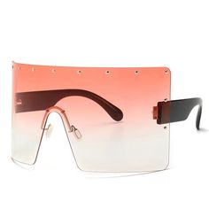 Indulge in the dramatic and luxurious style of our Trendy Oversized Sunglasses. These one-piece sunglasses feature rivet details and a windproof design, making them the perfect choice for any sunny day. Protect your eyes from harmful rays with UV400 lenses while elevating your look with these oversized shades. Embrace the opulent and refined aesthetic of our Trendy Oversized Sunglasses. Each pair boasts rivet accents and a windproof construction, creating a bold statement for any sunny occasion. Not only do these UV400 lenses shield your eyes from harmful rays, but they also elevate your style with their oversized silhouette. Frame Material: Polycarbonate Lenses Material: Polycarbonate Lenses Optical Attribute: UV400 Lens Height: 82 mm Lens Width: 90 mm Weight: 43.2 g Modern Shield Sunglasses For Beach, Beach Shield Sunglasses With Uva Protection, Adjustable Plastic Shield Sunglasses For Beach, Shield Sunglasses With Uva Protection For Beach, Modern Shield Sunglasses With Tinted Lenses For Vacation, Rimless Shield Sunglasses For Summer Parties, Modern Shield Sunglasses With Uva Protection For Beach, Trendy Sunglasses With Uva Protection For Pool, Modern Anti-reflective Shield Sunglasses For Vacation