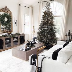 a living room filled with furniture and a christmas tree