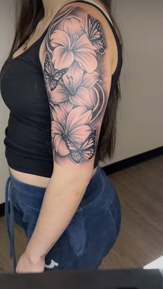 a woman with a butterfly tattoo on her arm and shoulder is posing for the camera