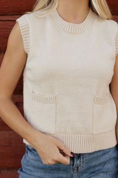 Stay cozy and stylish with the Carolynn Sweater Vest in Beige. This unique vest features two front pockets and a more fitted design for a flattering silhouette. Perfect for layering and adding a touch of warmth to any outfit. (Warning: may cause excessive hugging due to sheer comfort!) *More fitted* Material Content: 42% Acrylic // 30% Polyester // 28% Nylon Material Pattern:Knitted Jyrikka is 5’3” and wearing a small Model Measurements: Jyrikka: Height: 5’3” // Chest: 32” // Waist: 27” // Hips: Trendy Beige Knit Sweater Vest, Everyday Beige Knit Sweater Vest, Beige Textured Knit Sweater Vest, Chic Beige V-neck Sweater Vest, Beige V-neck Vest With Pockets, Boutique Clothing Store, Childrens Clothing Boutique, Rust Dress, Trendy Prints