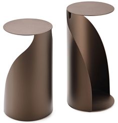 two modern side tables made out of metal and wood, one with a curved top