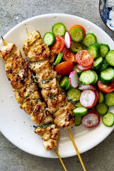 a white plate topped with meat and veggies