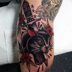 a black and white cat with flowers on its head is shown in this tattoo design