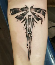 a tattoo on the leg of a person with a knife in it's center