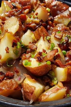 potatoes with bacon and green onions in a pan