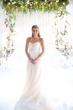 a woman in a wedding dress posing for the camera