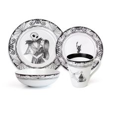 a white and black dinnerware set with a skeleton on the plate, cup and saucer