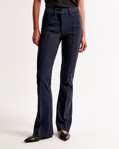 Elevate your wardrobe with the Abercrombie & Fitch Women's High Rise Flare Pants in a sophisticated Dark Indigo. These pants are designed to flatter your figure, featuring a high-rise waist that fits snugly at the hips and thighs before flaring elegantly at the knees into a full-length leg. Crafted from a stretchy, durable fabric, these pants ensure both comfort and style.

- **Size**: 26
- **Color**: Dark Indigo
- **Material**: Body: Polyester blend; Pocket Bag: Polyester
- **Gender**: Female
- Fitted Straight Leg Elastane Pants, Fitted Elastane Straight Leg Pants, Casual Fitted Bottoms With Seam Detailing, Fitted Mid-rise Fall Bottoms, Classic Mid-rise Bottoms With Seam Detailing, Fitted Wide Leg Bottoms For Fall, Chic Fitted Flare Jeans For Work, Classic High Rise Elastane Bottoms, Full-length Elastane Bottoms For Business Casual