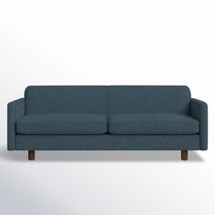 a blue couch sitting on top of a white wall