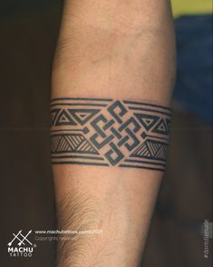 a man's arm with a tattoo design on the side of his leg and wrist