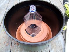 an empty water bottle sitting in a pot