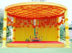 an orange and yellow stage set up for a wedding