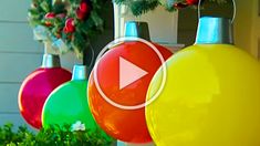 christmas ornaments hanging from the side of a house