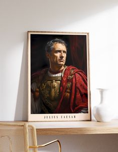 a portrait of a man wearing a red cape on top of a wooden shelf next to a white vase