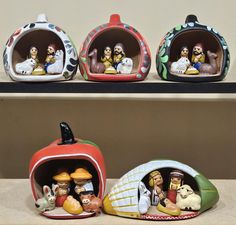 three ceramic figurines sitting on top of a shelf