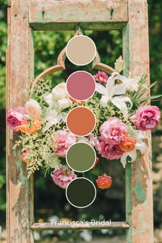 an old wooden frame with flowers and greenery arranged in the shape of a flower arrangement